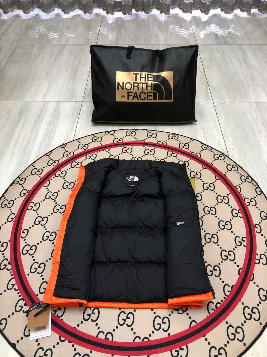 The North Face Quilted Orange and Black Puffer Vest