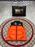The North Face Quilted Orange and Black Puffer Vest