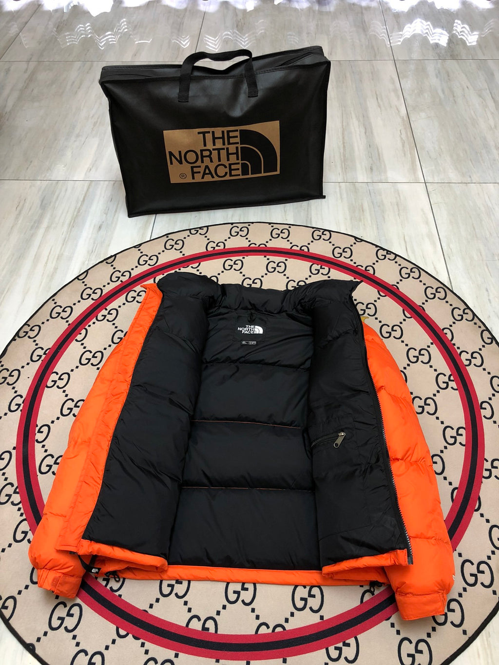 The North Face Quilted Orange and Black Stand-Collar Puffer Jacket
