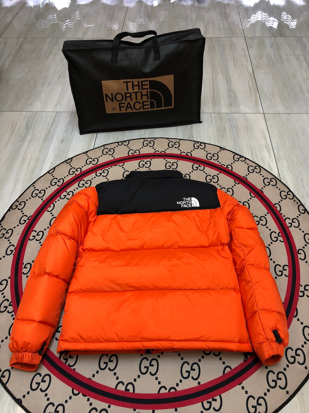 The North Face Quilted Orange and Black Stand-Collar Puffer Jacket