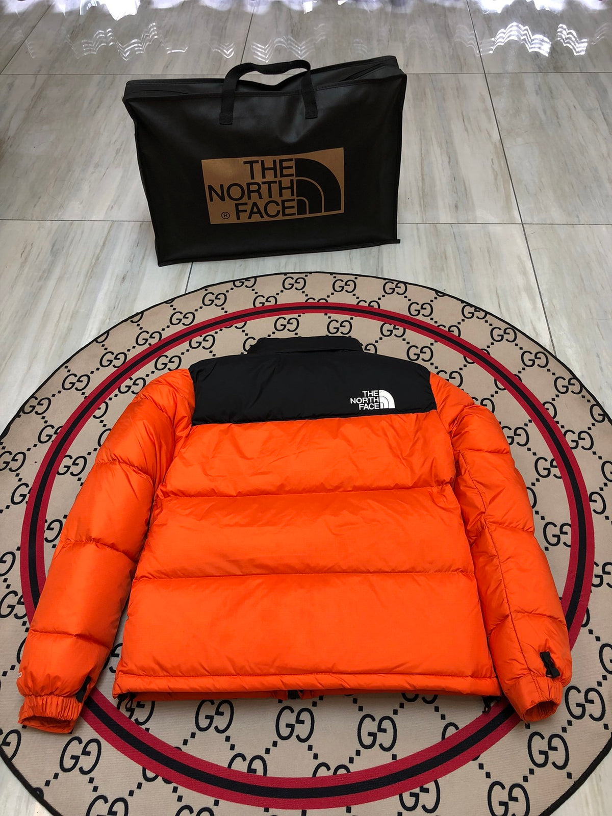 The North Face Quilted Orange and Black Stand-Collar Puffer Jacket