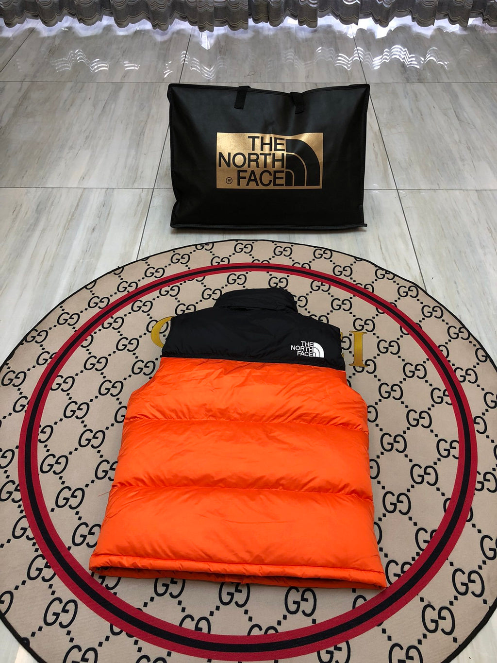 The North Face Quilted Orange and Black Puffer Vest