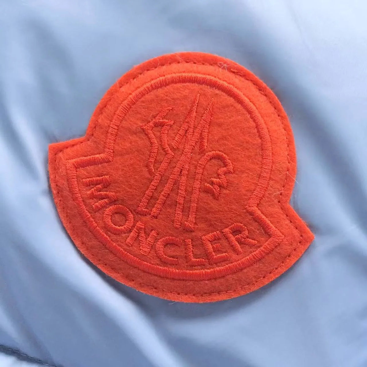 Moncler Light Blue Hooded Puffer Jacket with Orange Logo