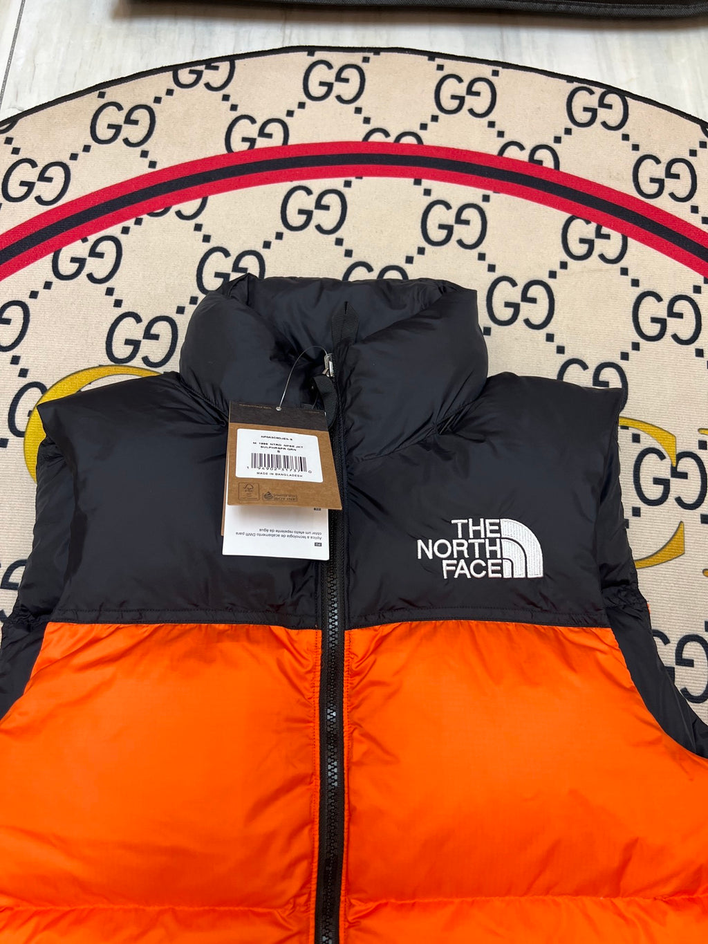 The North Face Quilted Orange and Black Puffer Vest