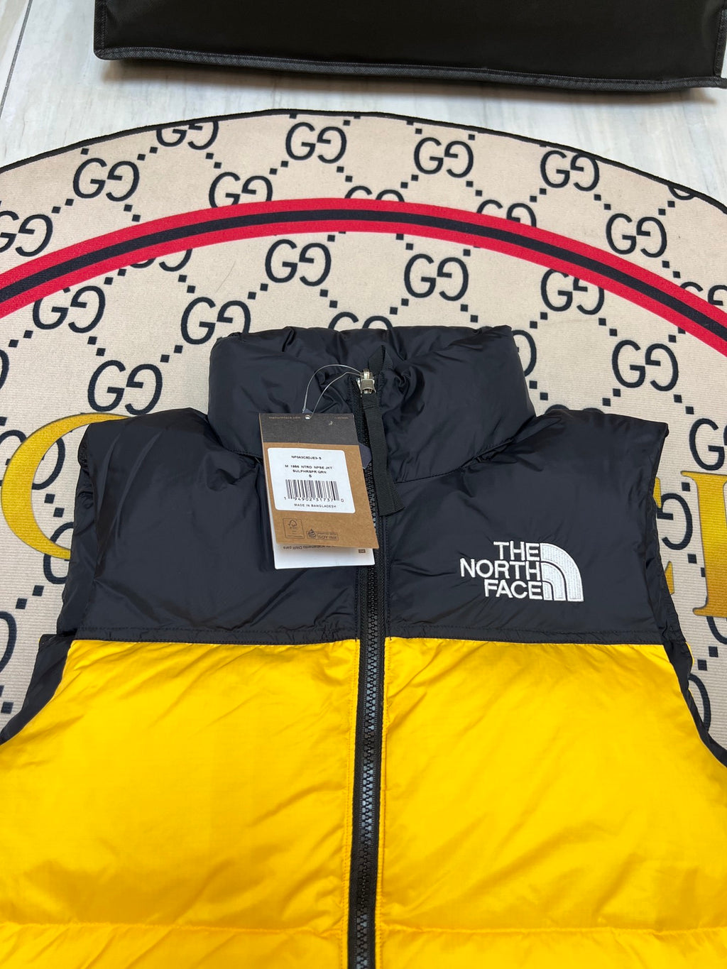 The North Face Quilted Yellow and Black Puffer Vest