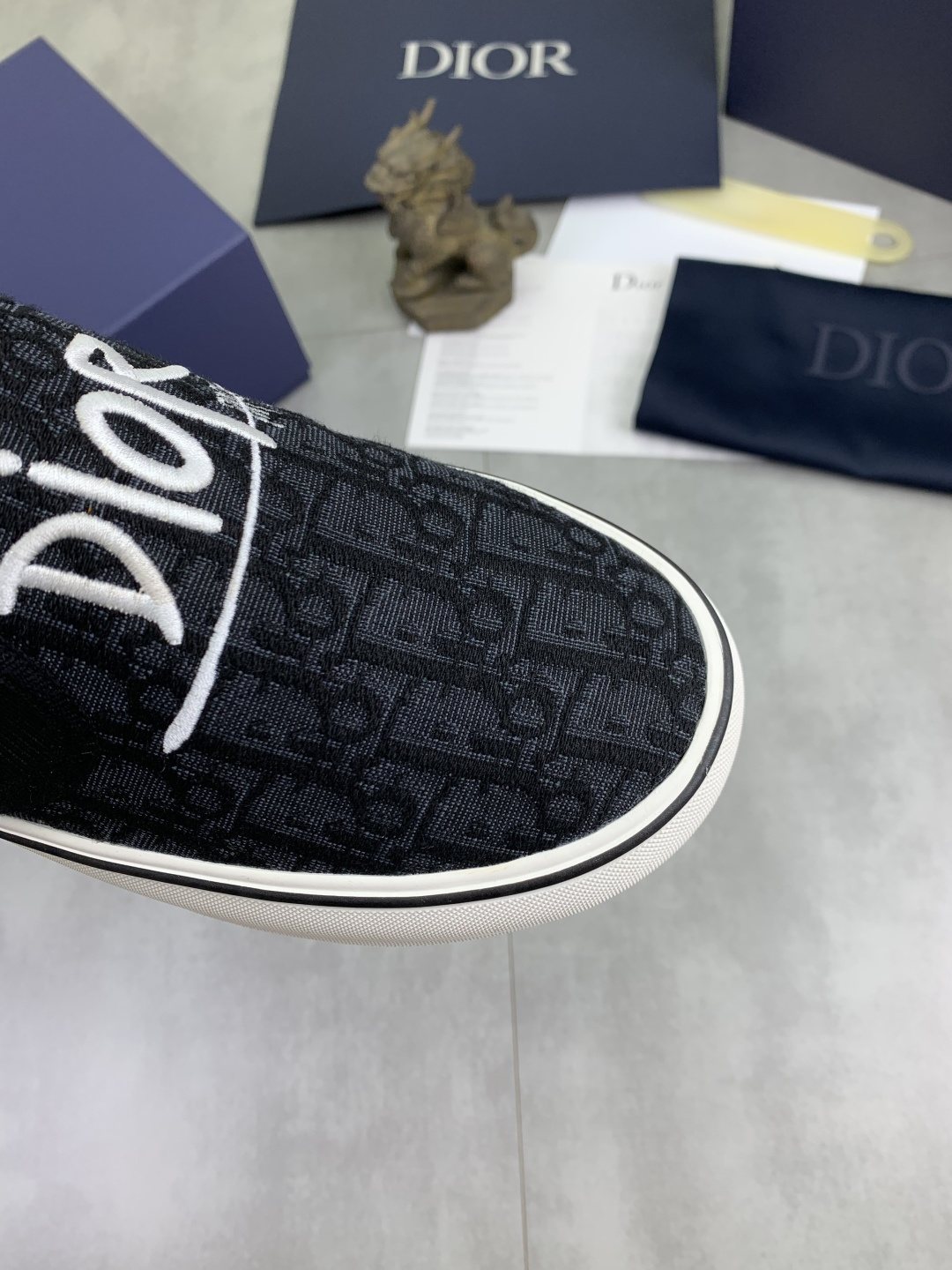 Dior Logo-Pattern Canvas Slip-On Sneakers - Black and White